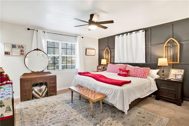 bedroom featuring ceiling fan and light carpet