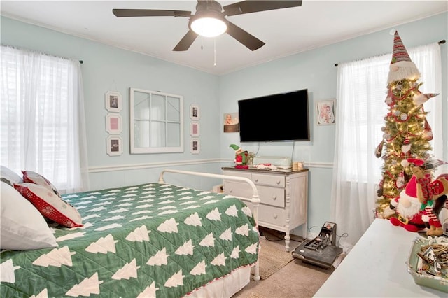 bedroom featuring ceiling fan and light carpet