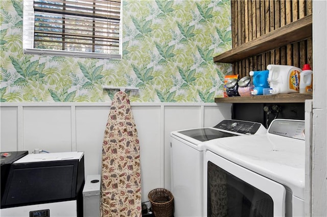 clothes washing area with separate washer and dryer