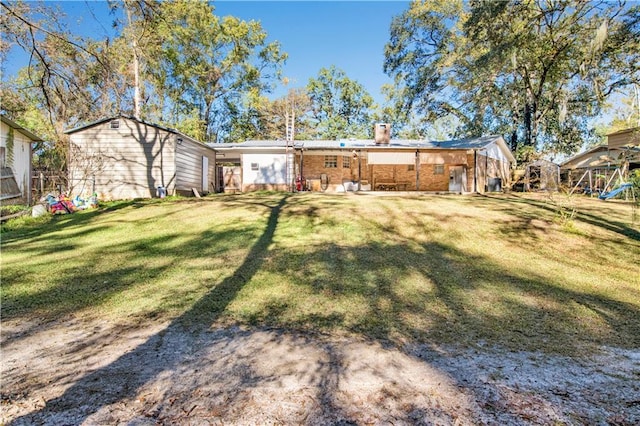 rear view of property with a lawn