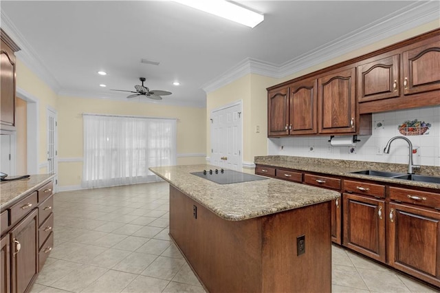 1140 Dominion Dr E, Mobile, AL 36695 - kitchen featuring black electric stovetop, a kitchen island, ceiling fan, crown molding, and light stone countertops