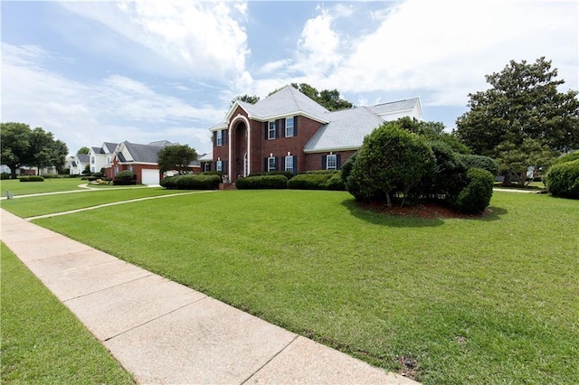 1140 Dominion Dr E, Mobile, AL 36695 - colonial inspired home with a front yard and a garage