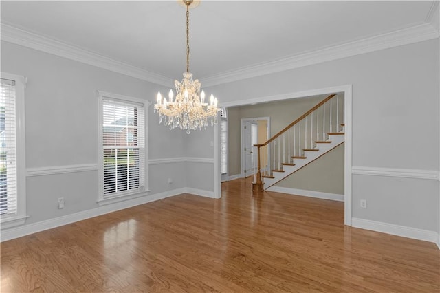 1140 Dominion Dr E, Mobile, AL 36695 - unfurnished dining area featuring a chandelier, wood finished floors, crown molding, and stairway