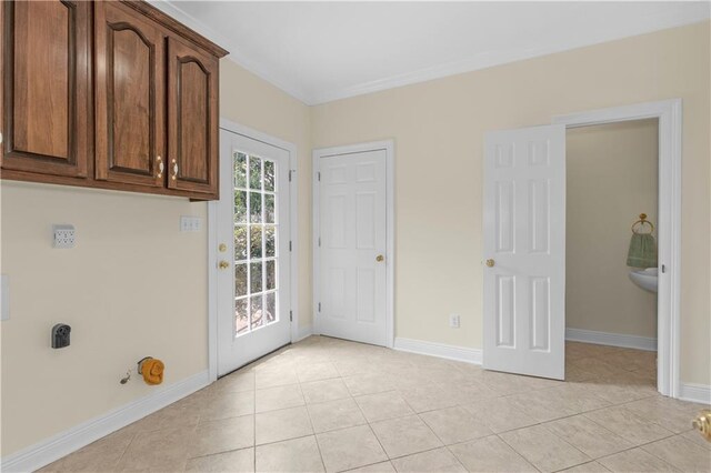 1140 Dominion Dr E, Mobile, AL 36695 - washroom featuring cabinet space, light tile patterned floors, and ornamental molding