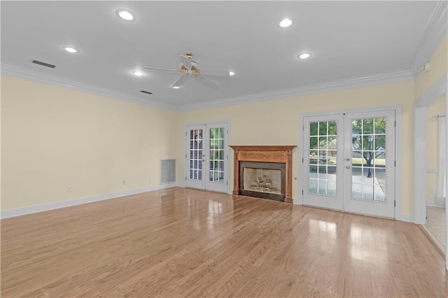 1140 Dominion Dr E, Mobile, AL 36695 - unfurnished living room featuring french doors, ceiling fan, ornamental molding, healthy amount of natural light, and light wood-style flooring