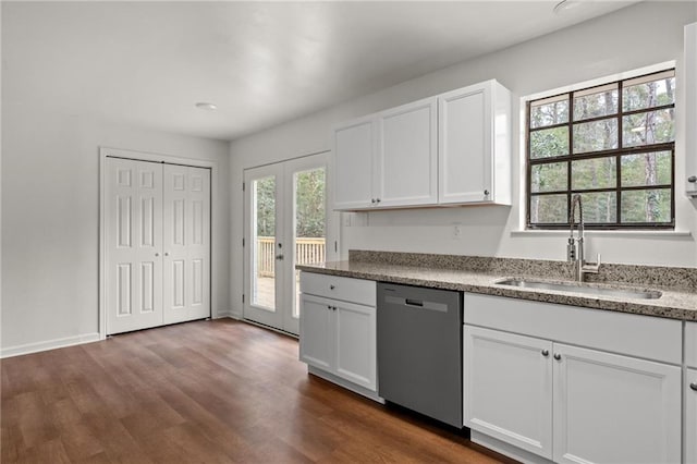 kitchen with dishwasher, dark wood finished floors, white cabinetry, and a sink