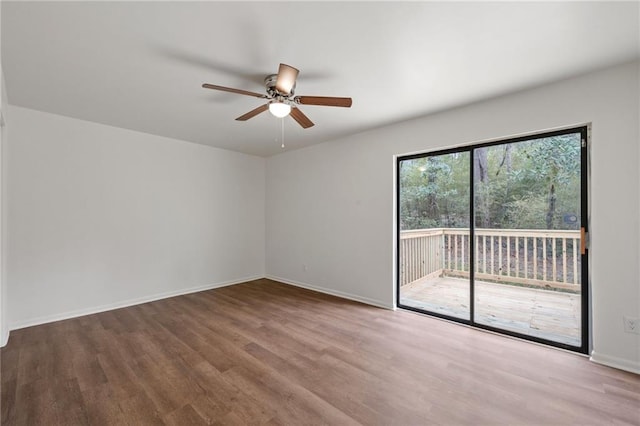 unfurnished room featuring ceiling fan, baseboards, and wood finished floors