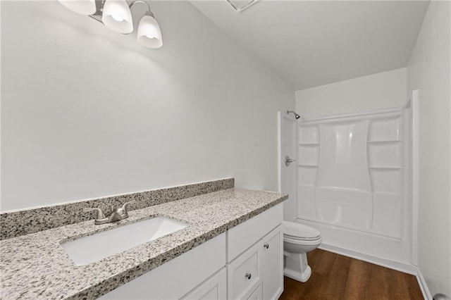 full bathroom featuring tub / shower combination, a chandelier, toilet, wood finished floors, and vanity