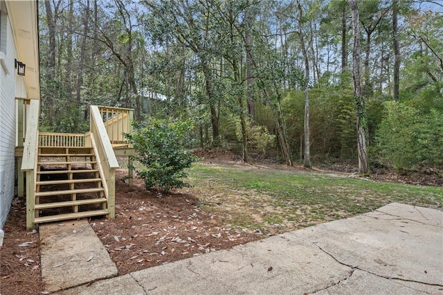 view of yard featuring stairs and a deck