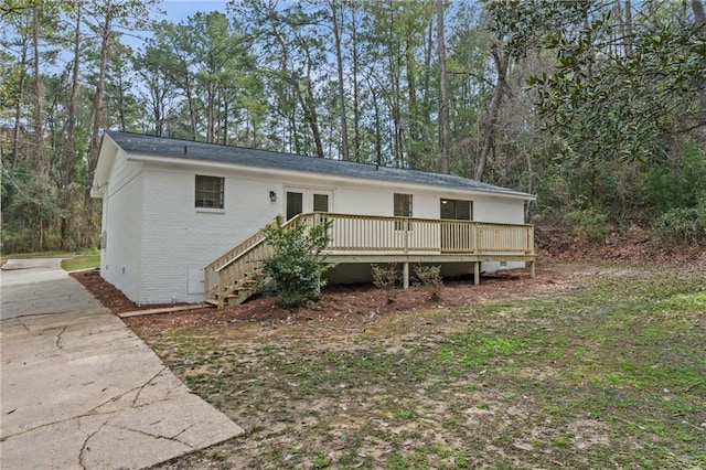 back of house with crawl space, french doors, brick siding, and a deck