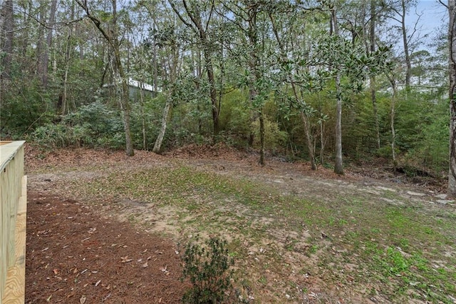 view of yard with a view of trees