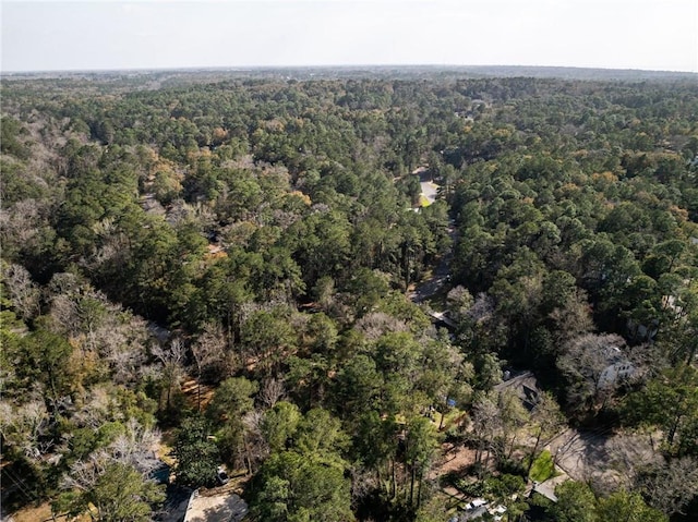 drone / aerial view featuring a view of trees