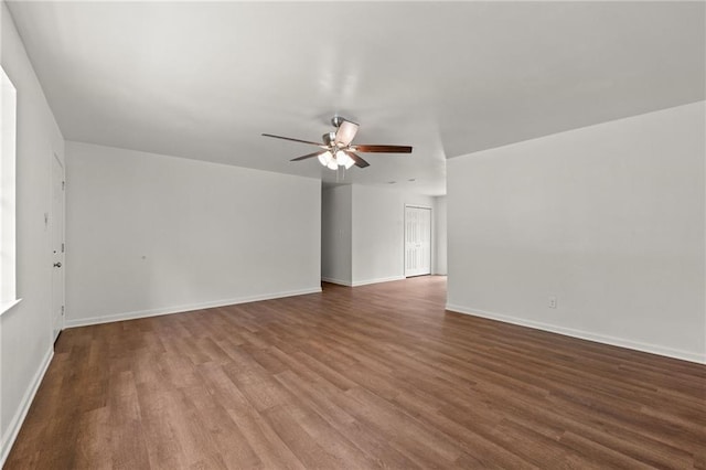 unfurnished room featuring baseboards, ceiling fan, and wood finished floors