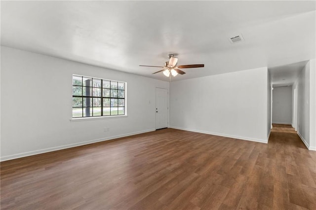 unfurnished room with visible vents, ceiling fan, baseboards, and wood finished floors