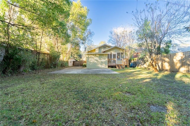 view of yard featuring a patio and a deck