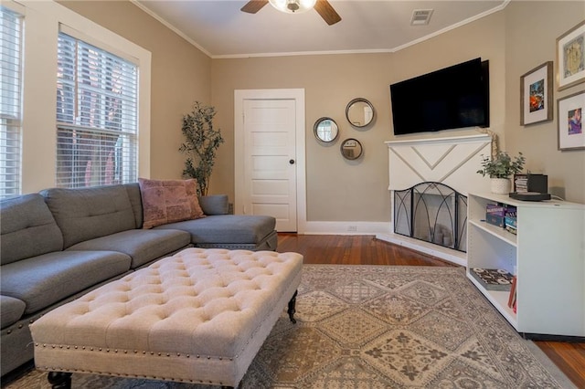 living room featuring ceiling fan, dark hardwood / wood-style flooring, and ornamental molding