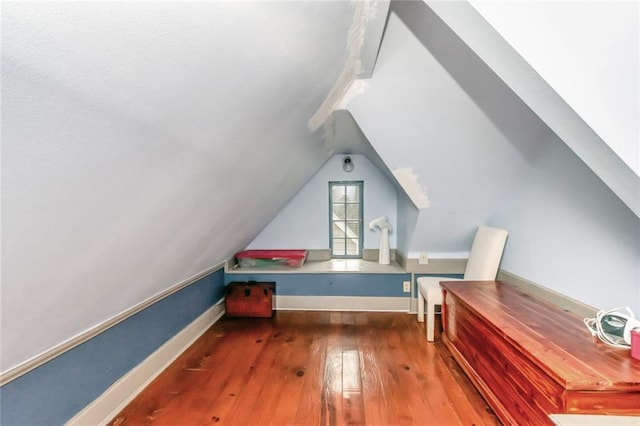 bonus room featuring dark wood-type flooring and lofted ceiling