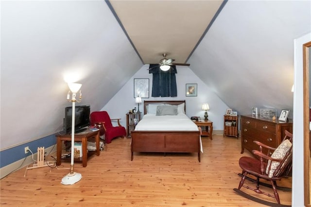 bedroom featuring light wood-type flooring, vaulted ceiling, and ceiling fan