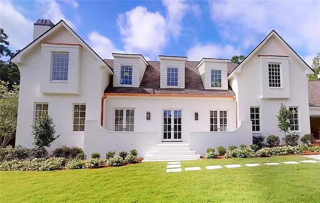 back of house with a yard and french doors