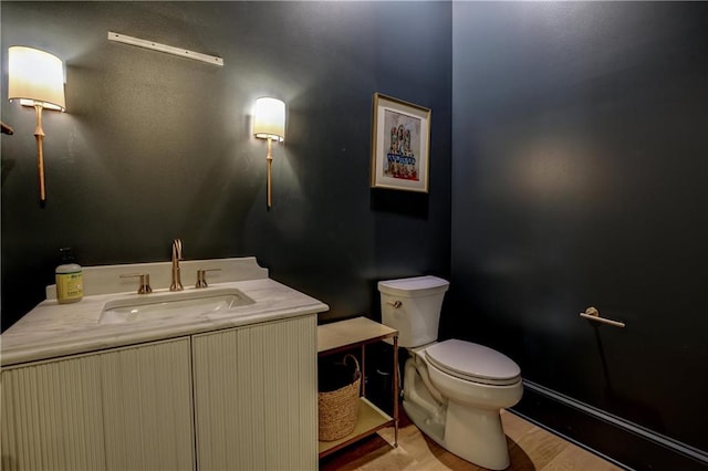 bathroom featuring hardwood / wood-style floors, vanity, and toilet