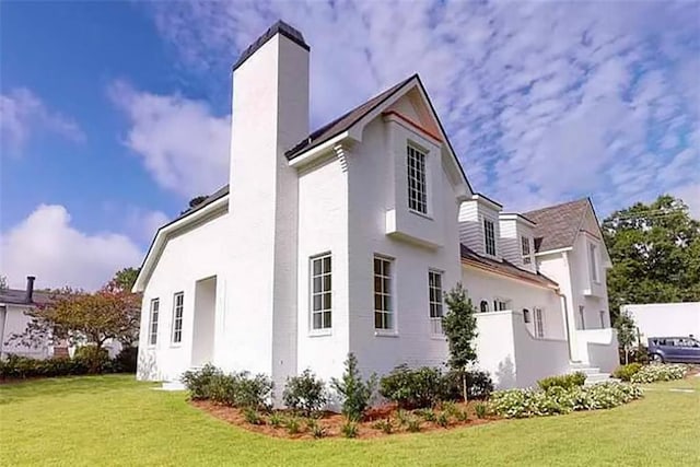 view of home's exterior with a yard