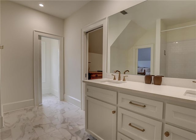 bathroom featuring a shower and vanity