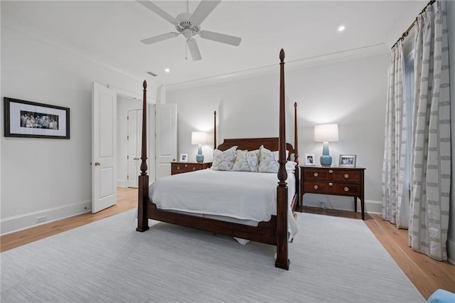 bedroom featuring ceiling fan, light wood-type flooring, and ornamental molding