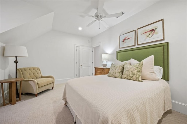 bedroom with light colored carpet, vaulted ceiling, and ceiling fan