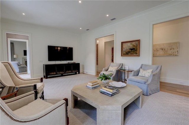 living room featuring light carpet and ornamental molding