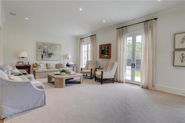 carpeted living room featuring a wealth of natural light and crown molding