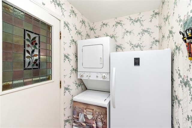 washroom featuring stacked washer and clothes dryer