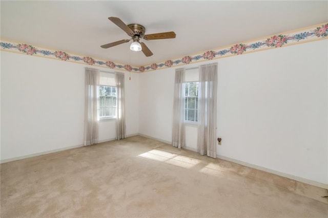 unfurnished room featuring ceiling fan, a healthy amount of sunlight, and light carpet