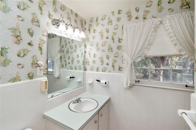 bathroom with vanity and tile walls