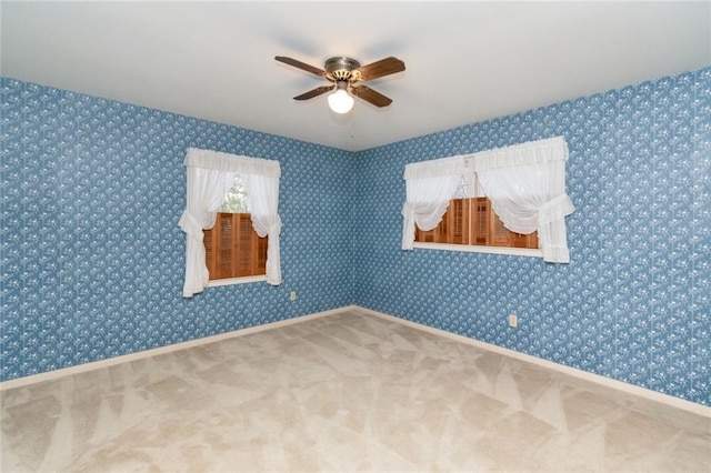 empty room featuring carpet floors and ceiling fan