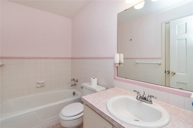 bathroom with vanity, a tub, tile walls, and toilet