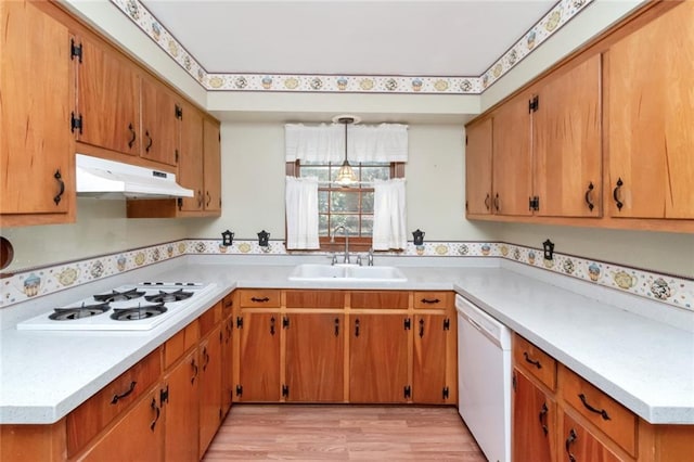 kitchen featuring sink, white appliances, and light hardwood / wood-style floors