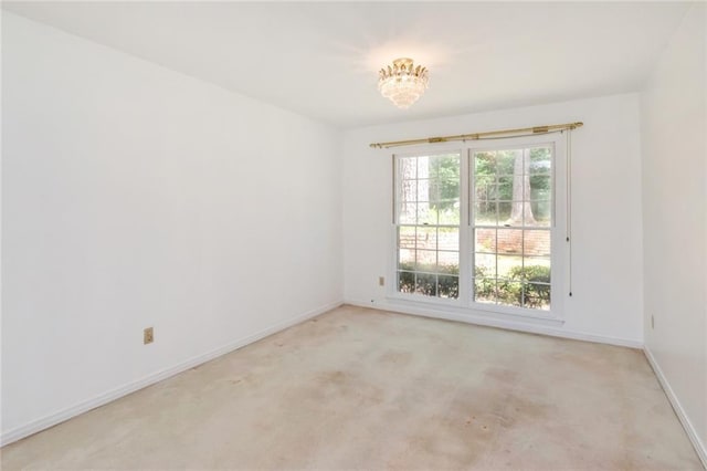 1805 Indian Creek Dr N, Mobile, AL 36607 - unfurnished room with light carpet, baseboards, and a chandelier