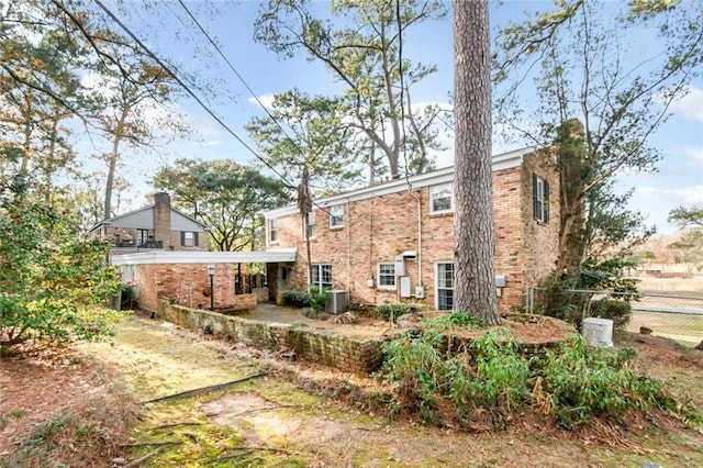 back of house with central AC unit