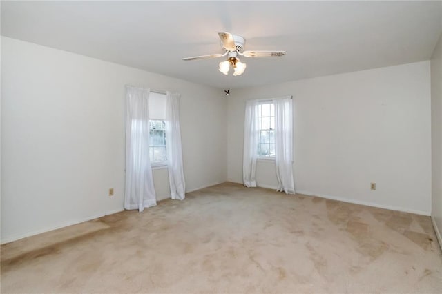 empty room featuring light carpet and ceiling fan