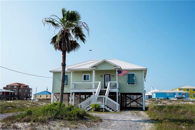 3150 State Highway 180, Gulf Shores, AL 36571 - raised beach house with covered porch, stairway, and a metal roof