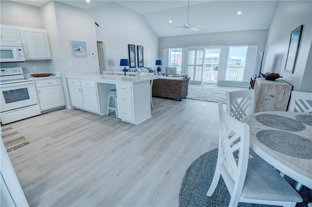 3150 State Highway 180, Gulf Shores, AL 36571 - kitchen with white appliances, open floor plan, a peninsula, white cabinets, and light wood finished floors