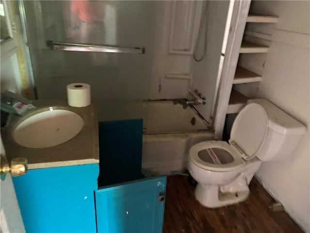 full bathroom with vanity, enclosed tub / shower combo, wood-type flooring, and toilet