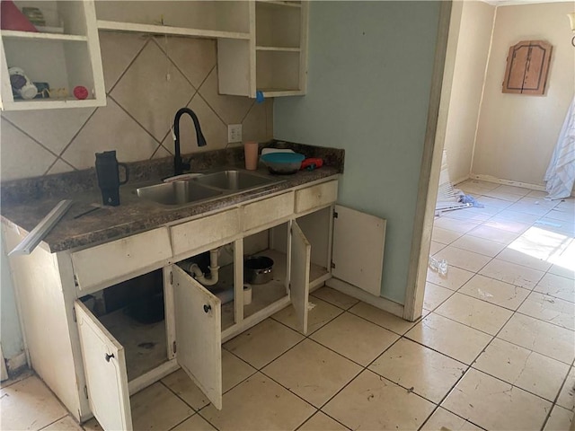 kitchen with sink, light tile patterned flooring, and backsplash