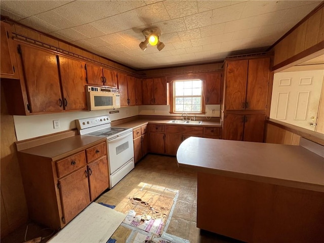 kitchen featuring white appliances and sink