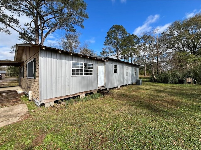 exterior space with a lawn and central AC