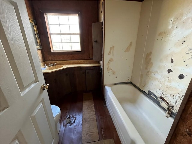 bathroom featuring a bathtub, vanity, wood-type flooring, and toilet