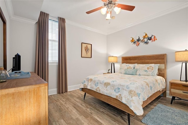 bedroom featuring crown molding, ceiling fan, and wood-type flooring