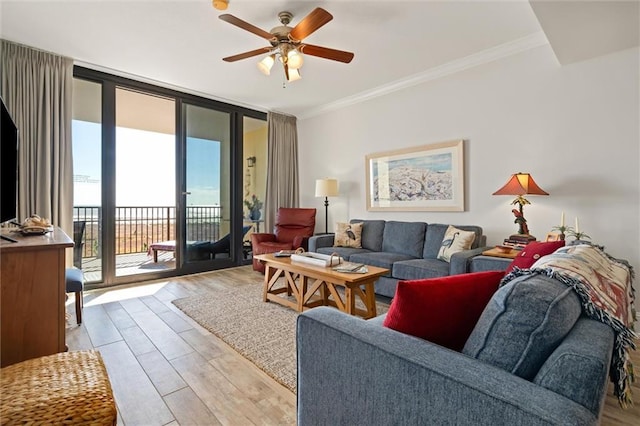 living room featuring crown molding, floor to ceiling windows, ceiling fan, and light hardwood / wood-style flooring