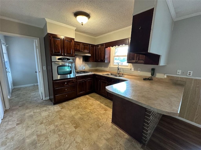 kitchen with kitchen peninsula, sink, a textured ceiling, appliances with stainless steel finishes, and crown molding