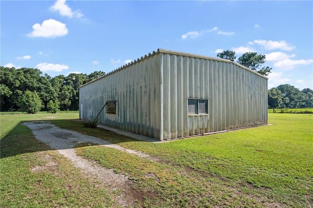 view of outbuilding featuring a yard